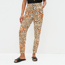 Load image into Gallery viewer, Orange Animal Print Jersey Joggers